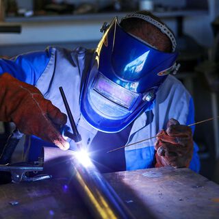 A welder welds metal together